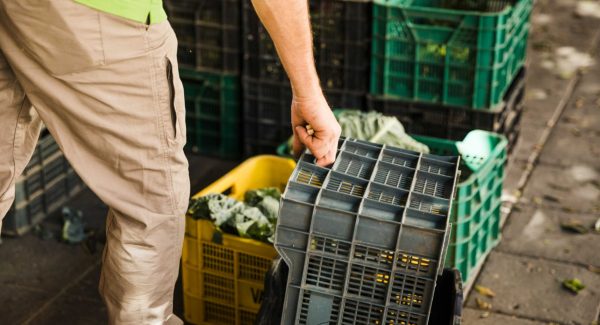 jpeg-optimizer_person-s-hand-holding-plastic-crate-supermarket